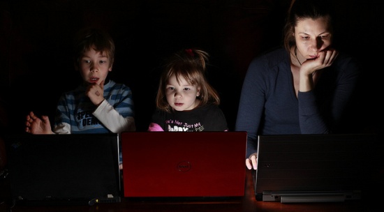 Parent and kids on computers